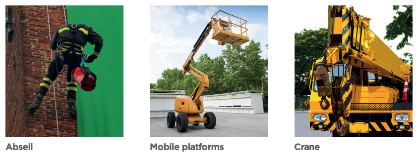 Man abselling down a wall wearing height safety gear, yellow mobile platform and yellow crane.