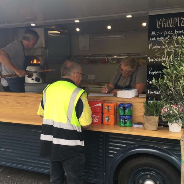 Worker wearing hi-vis ordering pizza