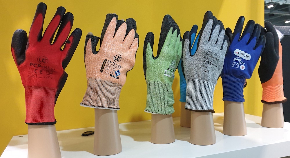 six sets of protective work gloves displayed in various colours