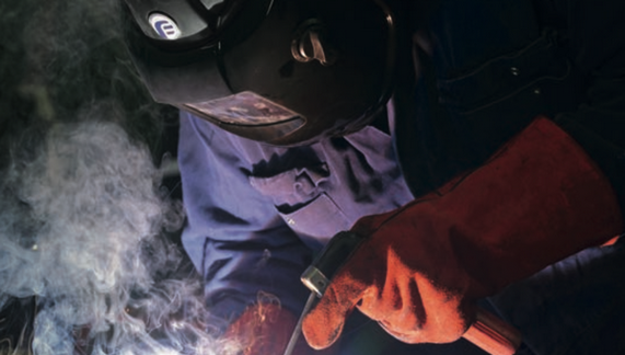 Male wearing a powered air respirators full face mask to protect lungs while working